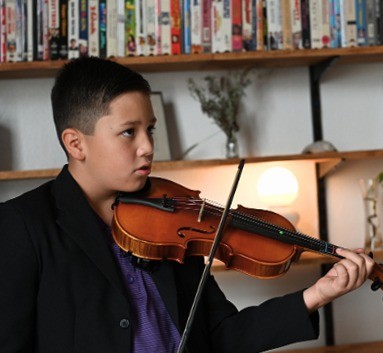 A young violinist performing at the Sound Birth final concert